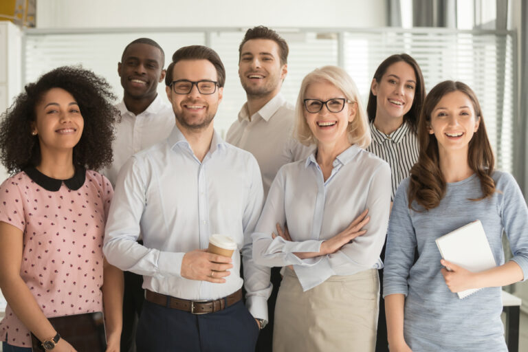 Smiling,Multiethnic,Employees,Standing,Looking,At,Camera,Making,Team,Picture